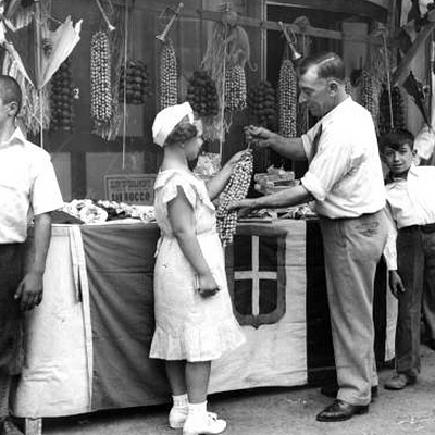 A vendor sells nuts during the Feast of the Assumption, 1935.