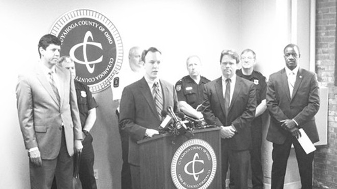 Ed FitzGerald, surrounded by county officials and safety leaders from various suburbs, announces a stricter approach to heroin investigations.