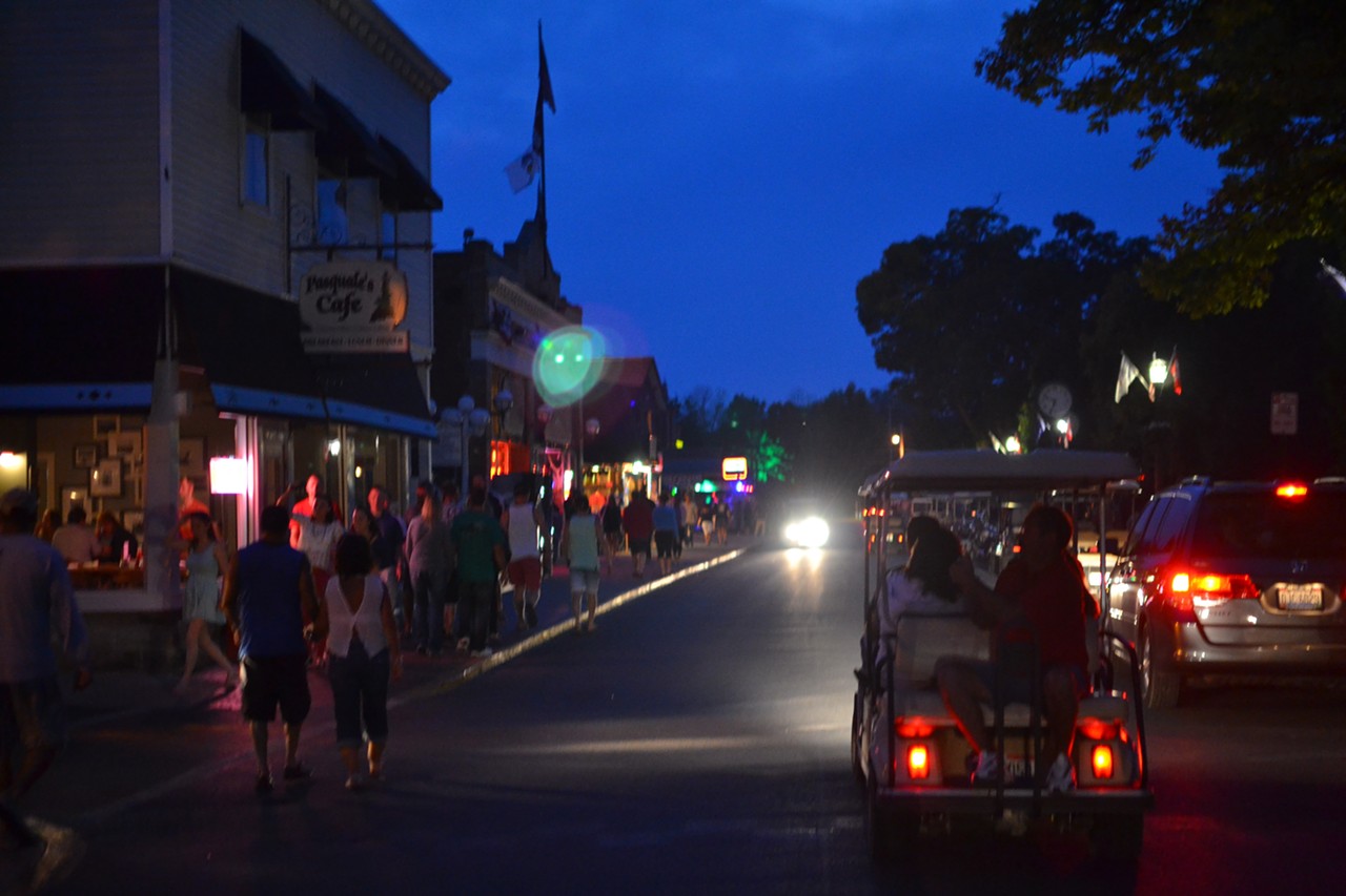 Golf carts and bar-goers on the island's main strip