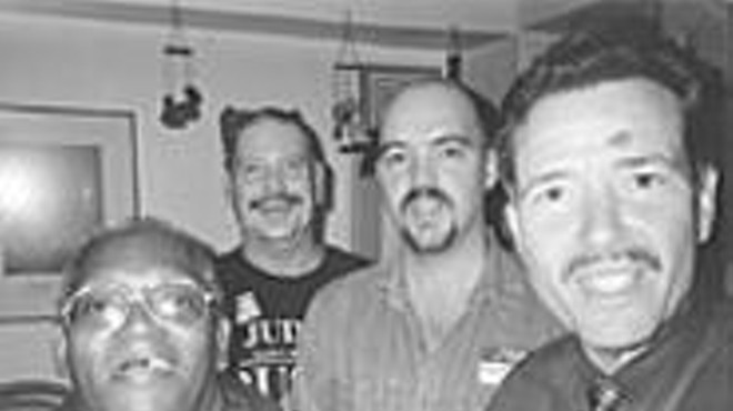 Greg Ammell (second from left), laughing with friends 
    at his Lakewood home.