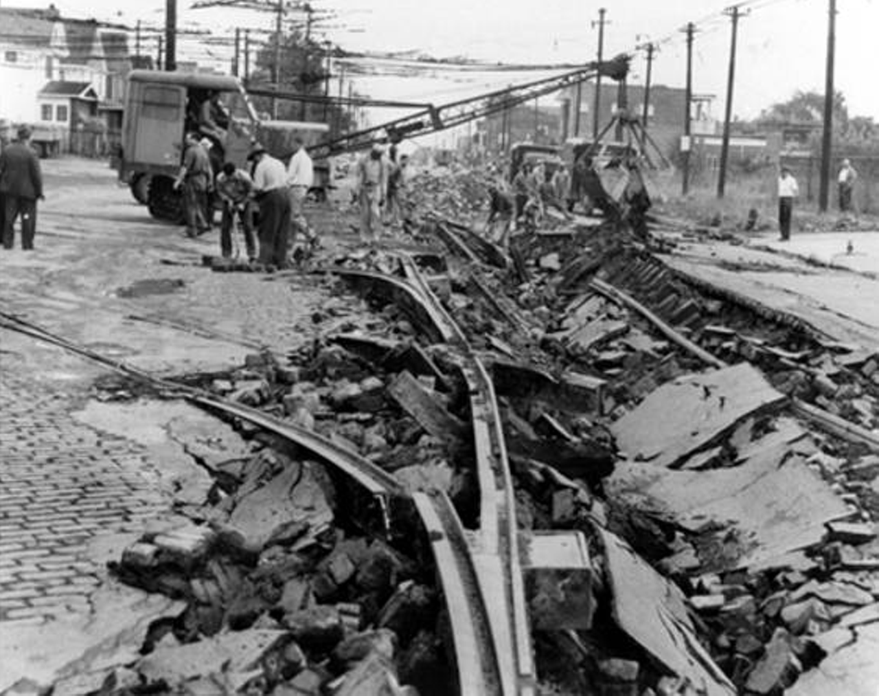 Scene looking north along West 117th St. from Madison Ave. as the repair crews clear the damage caused by the September 11, 1953 explosion.
