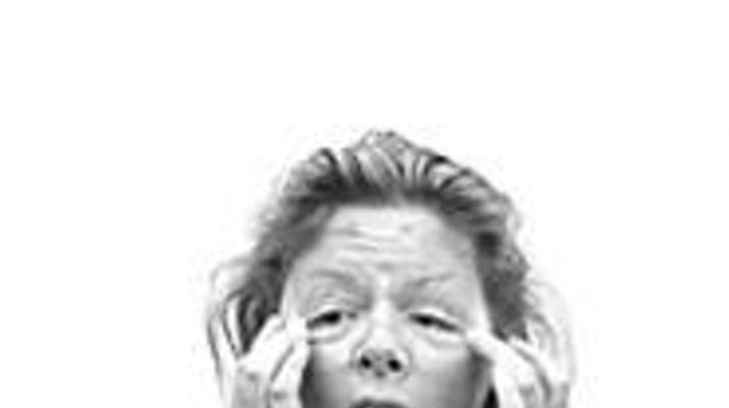 The real Aileen Wuornos, freaky lack of eyebrows and 
    all, strikes a scary pose.