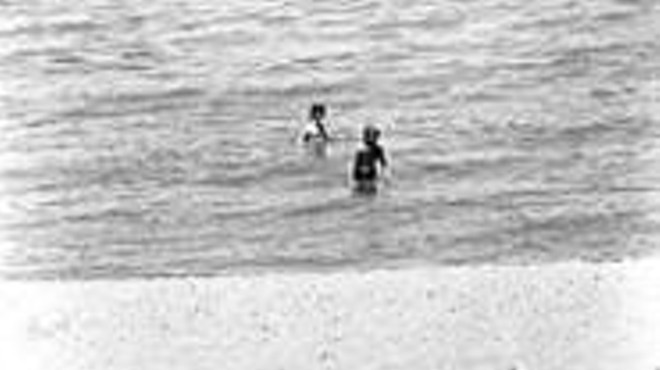Young swimmers at Sims Beach, where a pipe releases raw sewage.