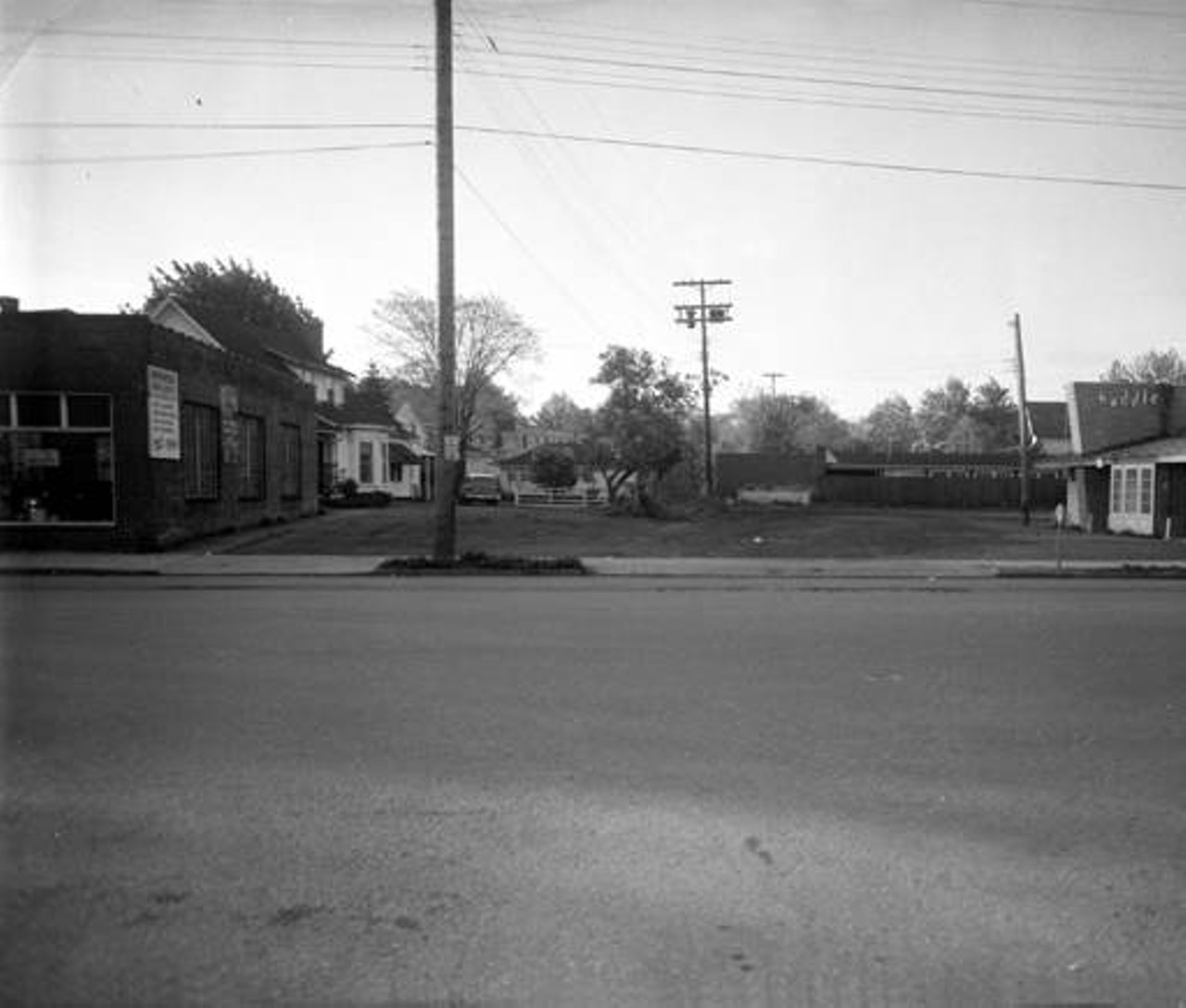 Huddle Drive-In Restaurant at 18235 Detroit Ave., near the Phelps Ave. intersection. Authorized Brake Service is on the left. c. 1959