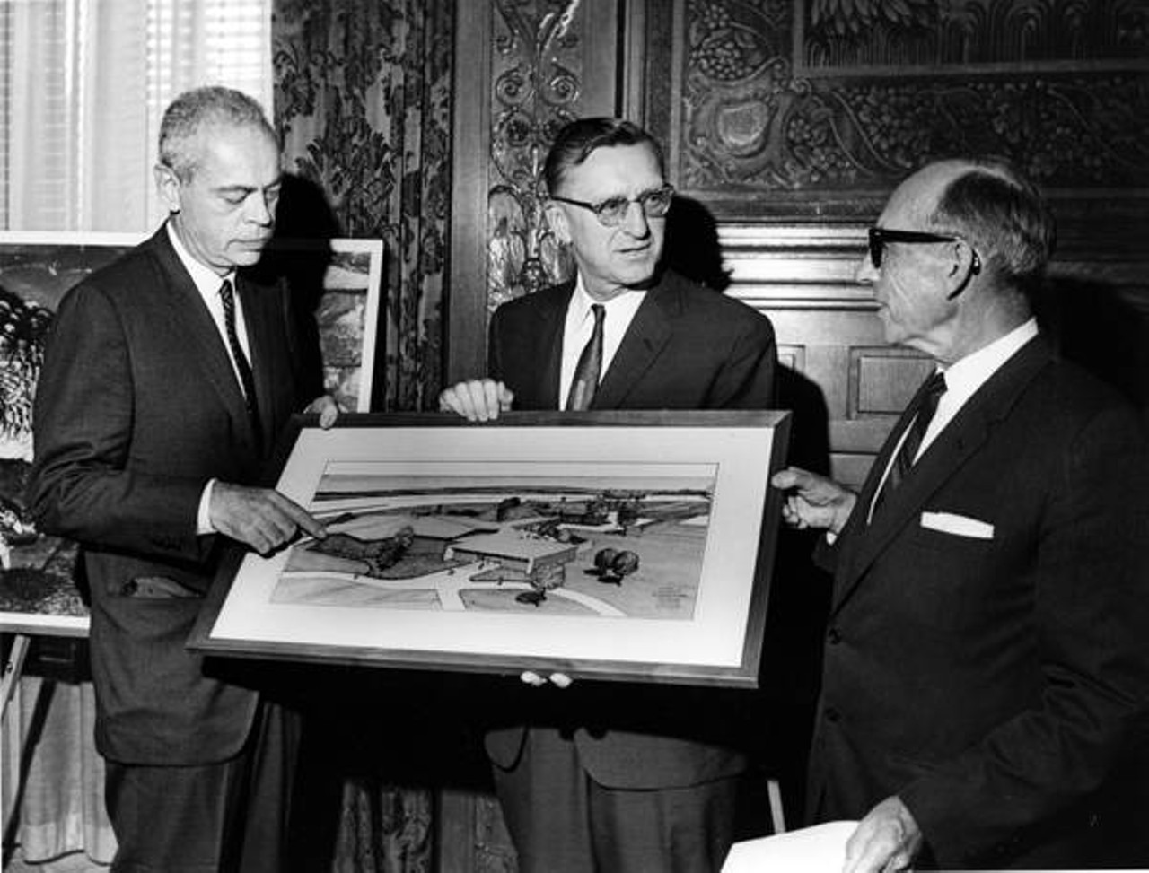 City officials hold architect's rendering of Cleveland Aquarium, 1965