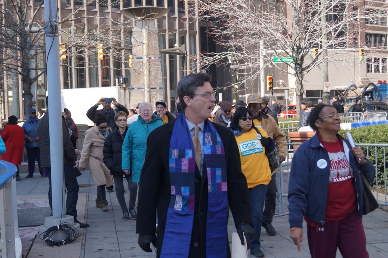 The Rev. John Lentz leads GCC members (from bus 2) to the plaza.