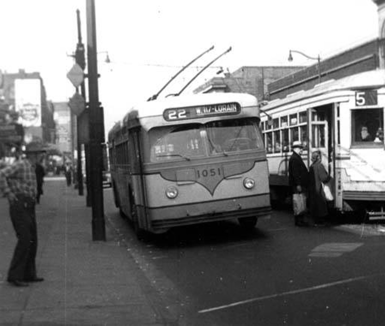 Cleveland Transit Car 4015 and Trackless Trolley 1051 at West 25th St. and Bridge Ave. in Cleveland, Ohio.