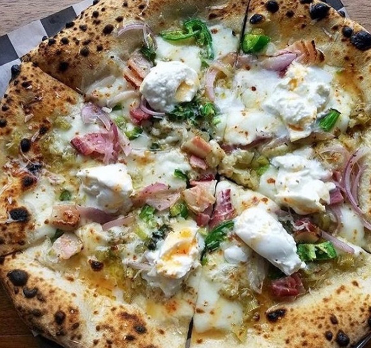 Citizen Pie 
15710 Waterloo Rd., 216-417-2742
While this fantastic pizzeria has opened up a location in Ohio City, the Collinwood spot is our favorite for pure coziness. The artisan wood-fired pizza is customizable, though the menu suggestions are pretty close to perfection.  
Photo via citizen.pie/Instagram