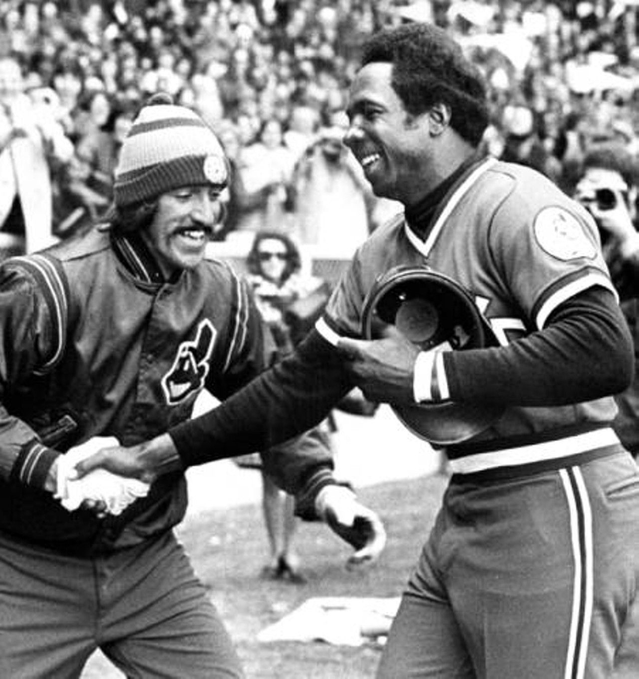 After homering in his first at-bat on Opening Day 1975, Cleveland Indians player-manager Frank Robinson is greeted by Tribe player John Lowenstein.