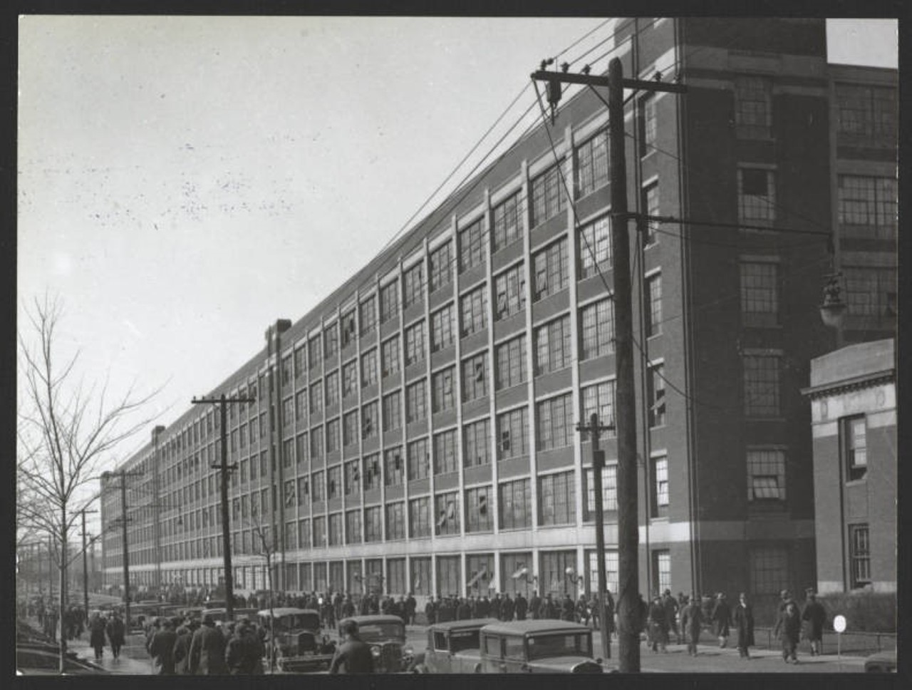 Factory located on St.Clair Avenue. On account of a strike of the Chevrolet Motor plant in Toledo, this plant was closed down in April, 1935 and 9,000 men were temporarily thrown out of work. The picture shows a view of the factory and some of the idle men. Fisher Body became a division of General Motors in 1926.