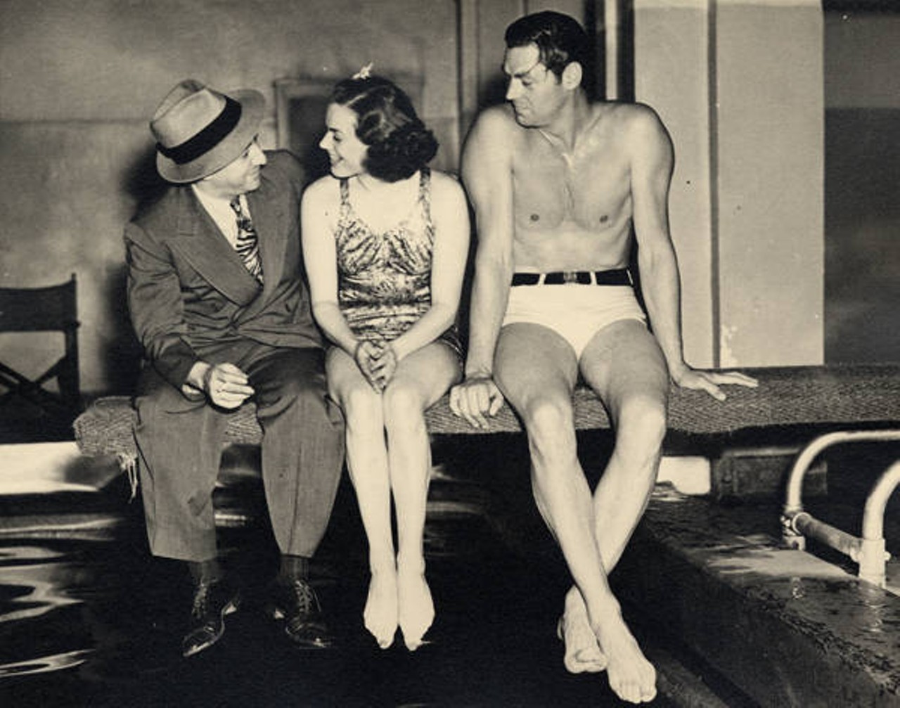 Billy Rose with Olympic swimmers Eleanor Holm and Johnny Weissmuller on a diving board at Billy Rose's Aquacade at the Great Lakes Exposition