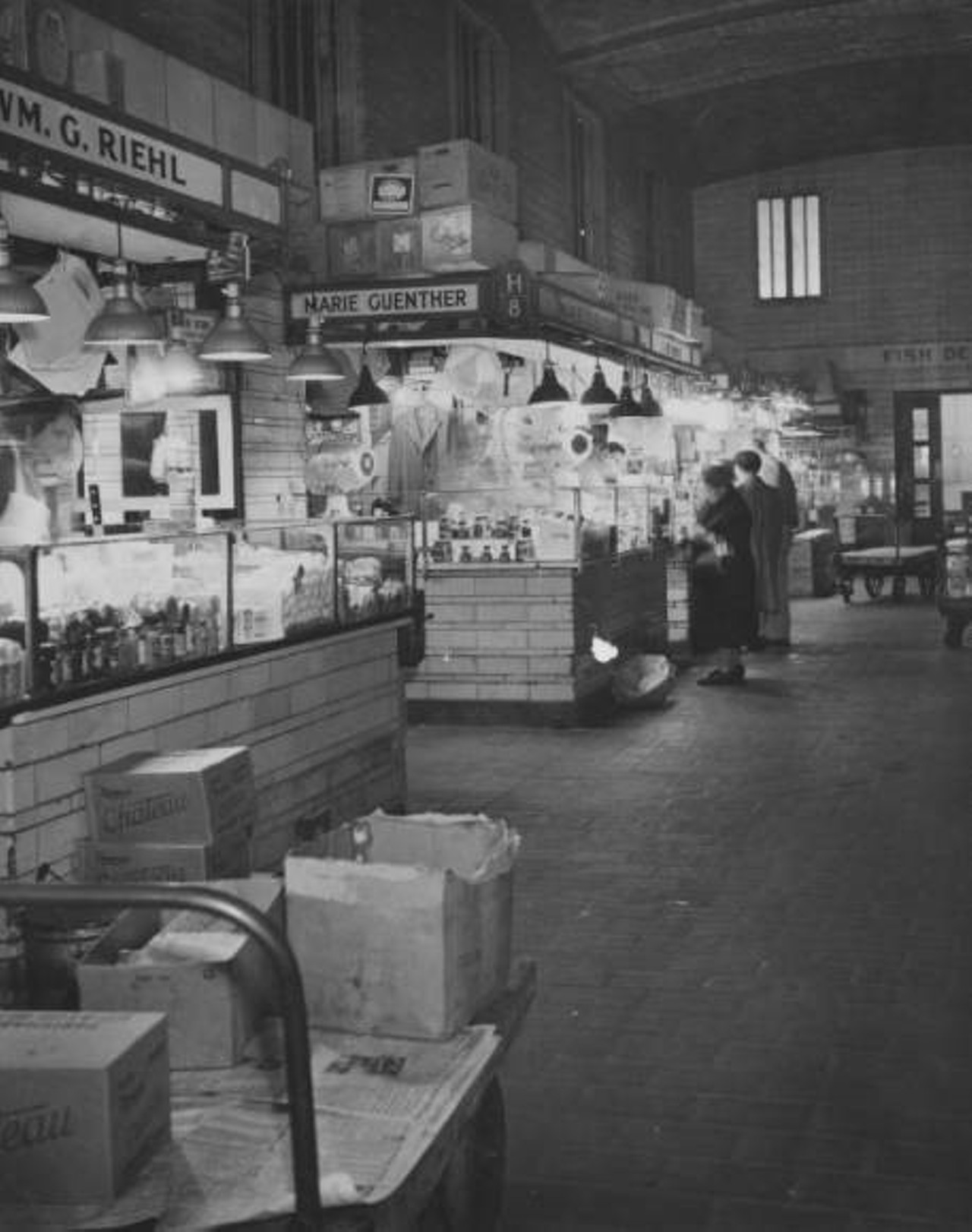 Interior view with few visible shoppers. Stalls for Wm G. Riehl and Marie Guenther at left. c. 1948