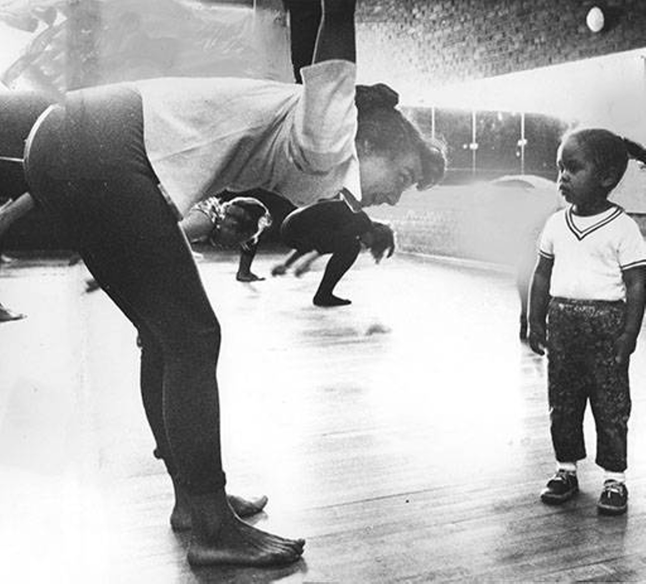 A young girl watches a dancer at Karamu House's 'Mother's Morning Out' dance class. 1964