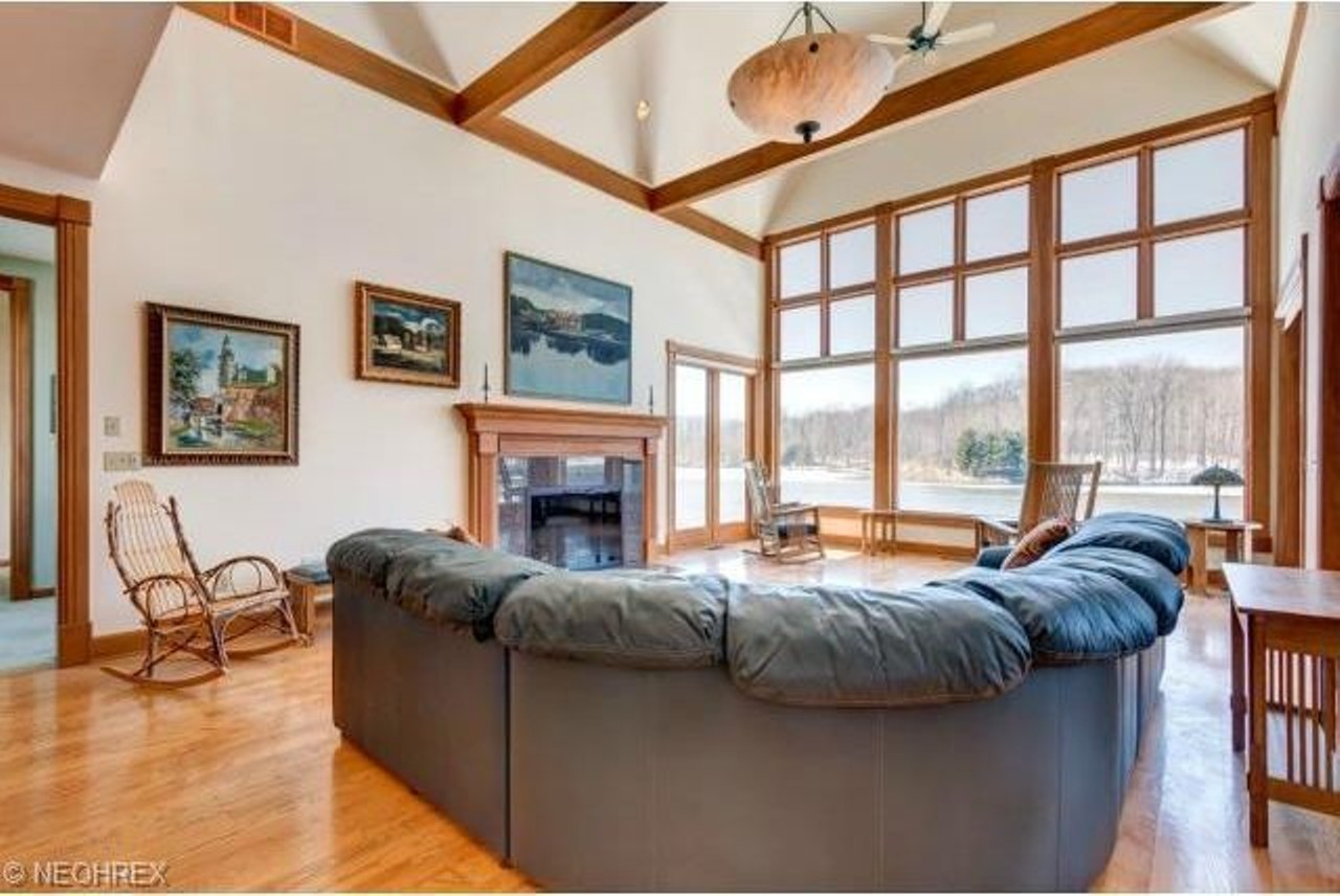 The living room boasts views of the 103 acre-plot, which includes a lake, a vineyard, and a farm.