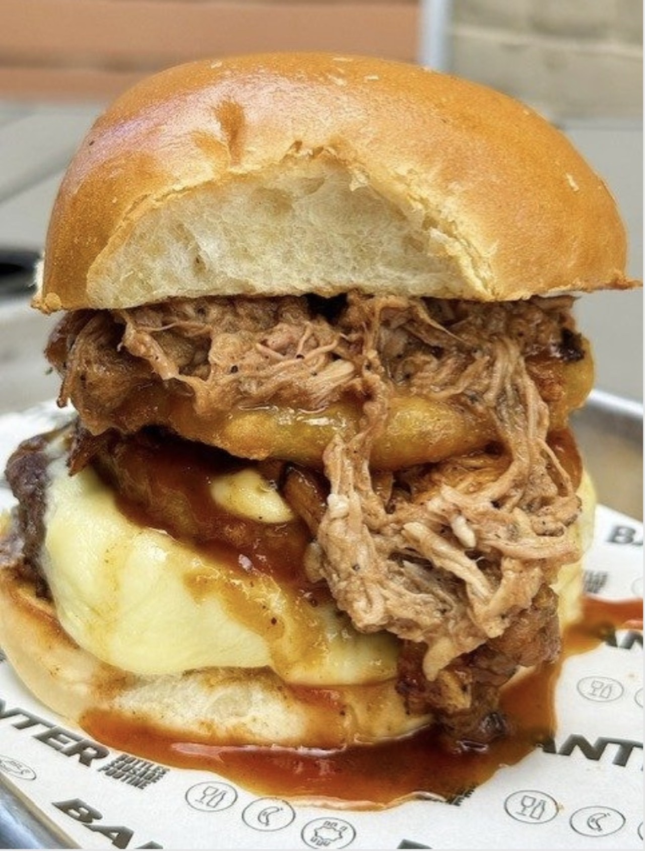 BANTER
Cowboy Burger: 1/3lb Burger Patty Topped With Coffee-Braised Pulled Pork, House-Made BBQ Sauce, and an Onion Ring. (Gluten free option available)