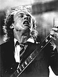 AC/DC's Angus Young makes a guitar face for - photographer Walter Novak. - Walter  Novak