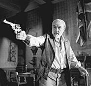 Allen Quatermain (Sean Connery) shoots at bad guys.