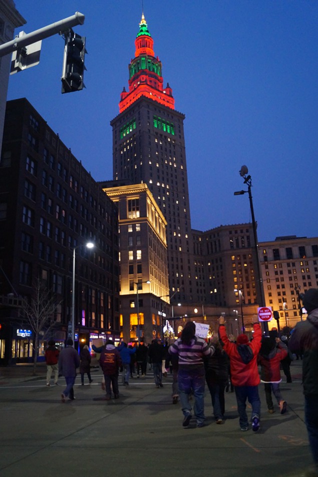 Terminal Tower decked out in Holiday green and red as protesters return to the Square. - SAM ALLARD / SCENE
