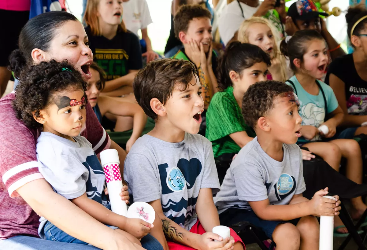Kids watching live education at a previous Clean Water Fest