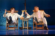 D. B. Bonds (left) and Tom Hewitt toast their own deviousness in Dirty Rotten Scoundrels.