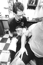Don Folmer draws a new tattoo for Art Porter, who - learned about tattoo-party regret the hard way. - WALTER  NOVAK