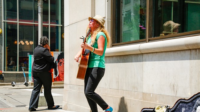 Kellie Clark, who goes by the stage name Thistle, plays on the corner of East 6th and Euclid Ave. on Wednesday, June 21, 2023.