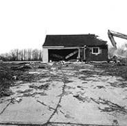 "House Being Demolished to Make Way for a Gated Community, Lyndhurst, Ohio," by Jeff Brouws, photograph.