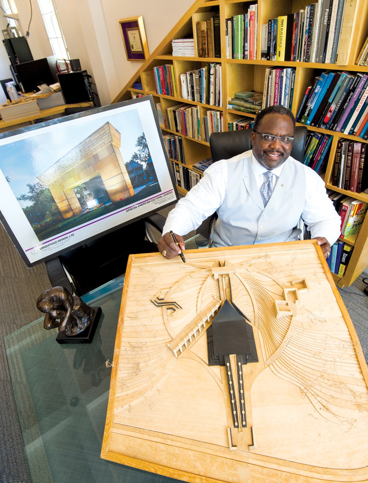 W. Daniel Bickerstaff
Principal, Ubiquitous Design, LTD
When architect Daniel Bickerstaff realized, with a start, that he wasn't just on the design subcommittee for the African-American Cultural Garden, he was in charge of spearheading the design, he went six months without picking up a pencil.
"That's unheard of for me," says the Shaker Heights resident, speaking at a conference table in his firm's office on Lee Road. "But I really wanted to understand this dual citizenship &mdash; this idea of being both African and American &mdash; before I put my ideas down."
Bickerstaff says during his extensive research of the harrowing Middle Passage and the experience of African-Americans in the United States, he would often find himself weeping at his computer screen.
"I'm a big guy, 285 pounds," says Bickerstaff, "but it was that emotional."
Bickerstaff, whose father is from Alabama, says he never discussed race with his family but that he sees the importance &mdash; no, the necessity &mdash; of doing so. "Just like our Jewish brothers and sisters," he says, "this country must embrace and express our history, even the awful parts. In doing so, we pay respect to those who survived. That's why I'm sitting here in this air-conditioned office."
Bickerstaff grew up in Hough (the 8200 block of Superior) and attended Cleveland public schools until the 10th grade, when he won a scholarship and finished high school in Boston. Afterward, he attended Washington University in St. Louis to study architecture, in defiance of a prominent professor who encouraged him to switch to social work. Energized, and proud of his academic accomplishments, he returned to Cleveland in 1986. After working in the private sector for a few years, he worked in the city's planning office. He was Mayor Michael White's chief architect before he set out on his own in 2002.
Since that time, his firm, Ubiquitous Design, LTD, has worked on an array of local projects. Bickerstaff has a passion for historic preservation and designed the Men's retail clothing store at Clifton Boulevard and Lake Avenue that used to be a BP gas station. He designed the red and metallic contemporary condos on Brayton Avenue in Tremont. He has designed churches and hotels and local parks.
(In case you're wondering &mdash; we couldn't resist asking &mdash; Bickerstaff's favorite building in Cleveland is the Terminal Tower. He worked there fresh out of college and has fond memories of, among other things, the fountain. He says he looks forward to what Tower City can be again, now that a sufficient downtown population exists to patronize the businesses there.)
But his crown jewel remains the cultural garden. Though only the $600,000 first phase of the $2.5 million project is complete, the finished portion is already an important symbol for Cleveland's African-American community. The garden was originally dedicated in 1977, but a committee to raise funds and build the memorial wasn't established until 2003.
The completed portion includes a large archway and a black corridor that signifies the Doorway of No Return in West Africa.
"These are torturous things we're representing," Bickerstaff says, of his concept, "but I wanted the design to be beautiful, to be elegant, and to be something we're proud of as a community."
Bickerstaff says the fundraising for the remaining phases is ongoing, and that he'll be involved until the final stone is laid.
"For me," he says, "it's a labor of love." &mdash; Sam Allard
