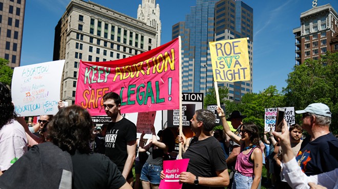 Supporters of reproductive rights attempt to cover the posters of counter protesters at a rally to support abortion rights less than two weeks after a leaked Supreme Court draft opinion showed a likely reversal of Roe v. Wade, May 14, 2022, at the Ohio Statehouse, Columbus, Ohio.