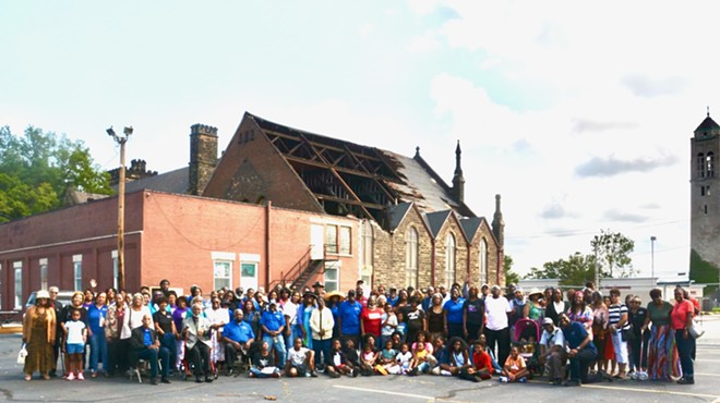 Members of the congregation of New Life at Calvary Church, standing in their parking lot after an EF-1 tornado destroyed part of its Fellowship Hall roof. Roofer estimates for the repair surpass, the pastors said, $4 million.