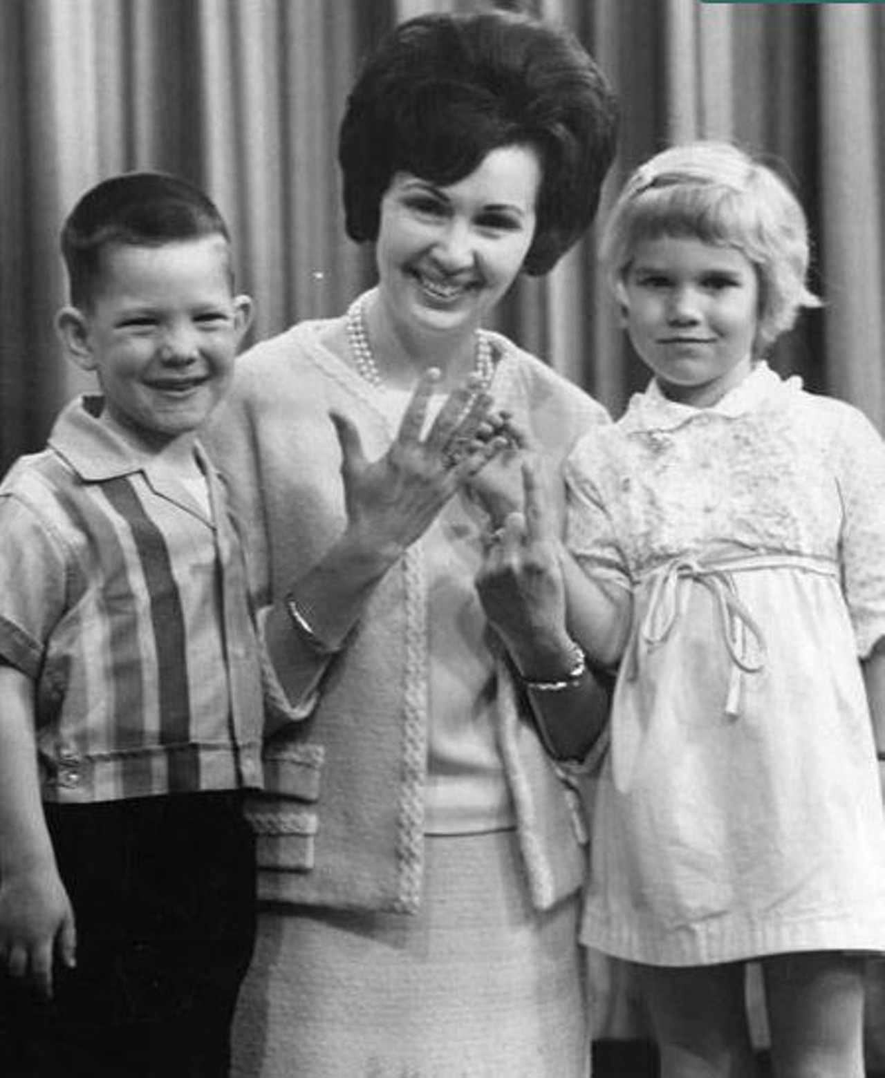 "Miss Barbara counts up her years as teacher on Romper Room on WEWS. She celebrates her sixth anniversary today. Helping her count are four-year-olds Jeff Hershman and Tammy Tilker who appear on the show this week (9:30 a.m., Channel 5) 4-28-66" -- photo caption.