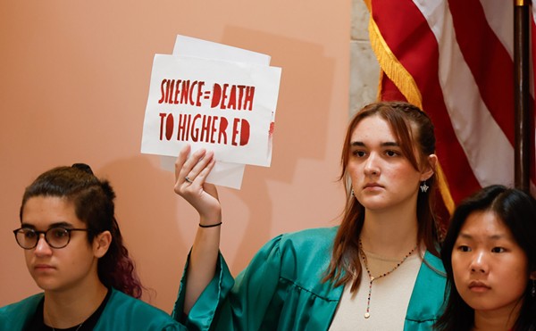 Jamie Pipik from the University of Akron holds up a sign during a protest led by the Ohio Student Association in opposition to Senate Bill 83, June 14, 2023, at the Statehouse in Columbus, Ohio.