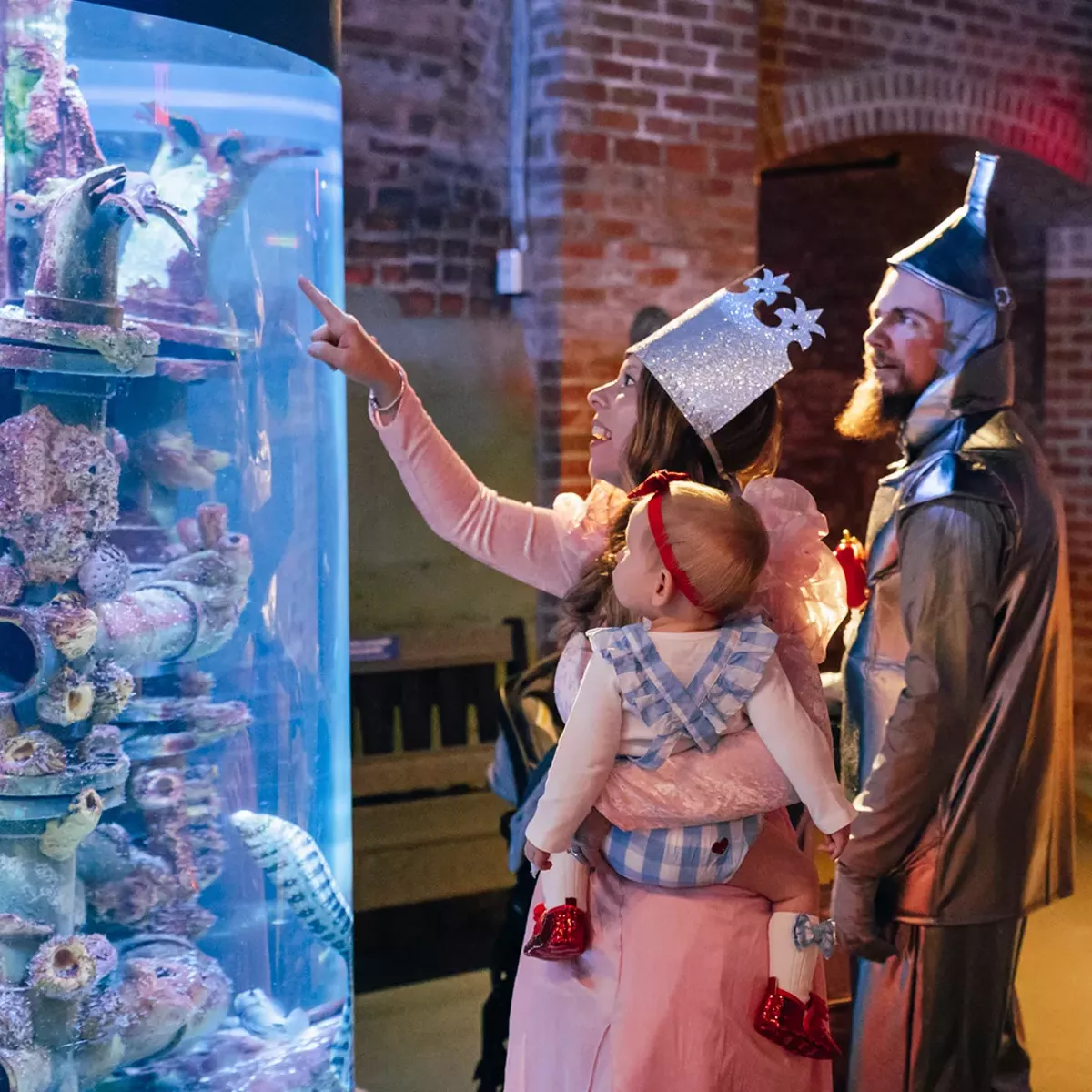 Family in costume for Pumpkins & Piranhas at Greater Cleveland Aquarium.