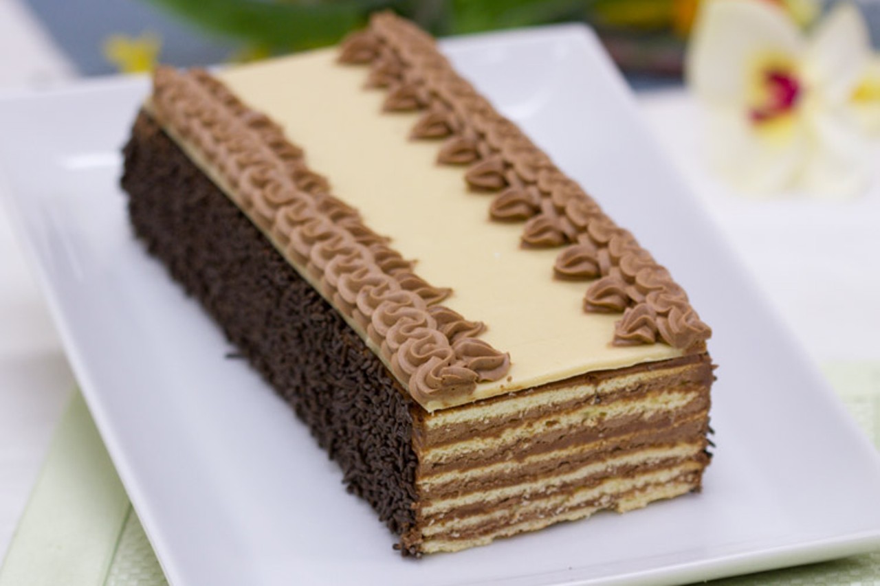 Farkas Pastry Shoppe, Hungarian Dobos Torte
Created by Hungarian pastry chef, Joska Dobos, this traditional torte is made by stacking six crisp, thin wafer cake layers with equal amounts of rich chocolate buttercream. Farkas’ adaptation is topped with handcrafted marzipan and decorated with the same decadent chocolate buttercream. Just look at that beautiful creation.
