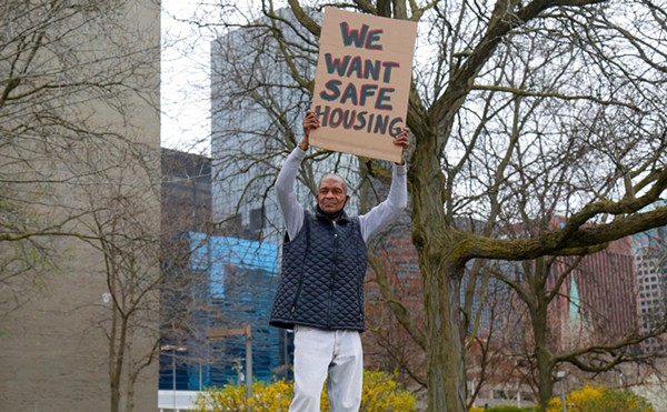 Marlon Floyd, a tenant at St. Clair Place, demonstrating in front of the complex on Wednesday.