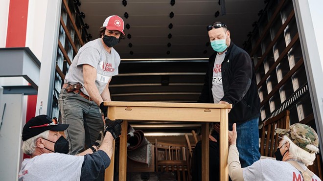 Team Rubicon volunteers help move in an Afghan family.