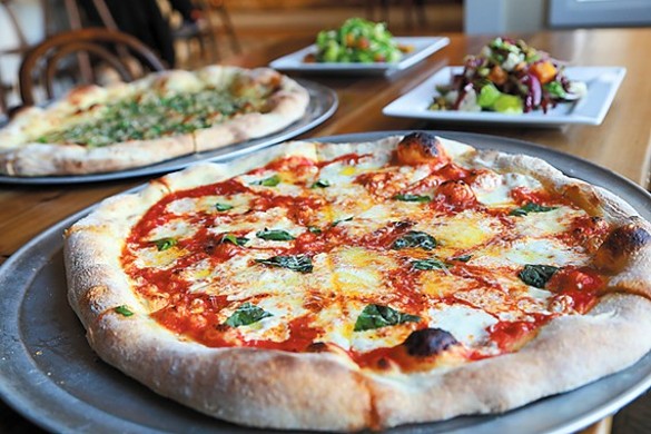 Il Rione Pizzeria
    1303 W. 65th St., 216-282-1451
    
    Il Rione might be "just a neighborhood pizza parlor," but it elevates the genre thanks to warm lighting, stylishly weathered interior, and a killer playlist from the golden age of rock. While the menu is spare, the New York/New Jersey style pizza exiting the open kitchen is amazing, with the clam pie taking the cake. Diners can choose from a half-dozen predesigned pies or can build their own from the crust up. Beer, wine, and cocktails round out the fun.
    
    Photo by Emanuel Wallace