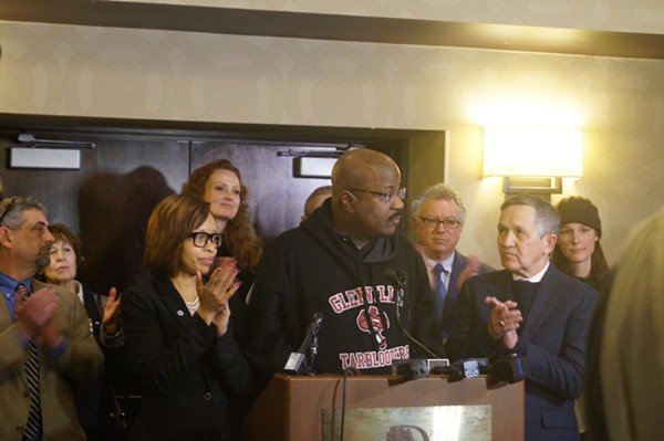 Councilman Kevin Conwell, flanked by Tara Samples and Dennis Kucinch, speaks about gun violence at Kucinich campaign event (2/19/2018). - Sam Allard / Scene