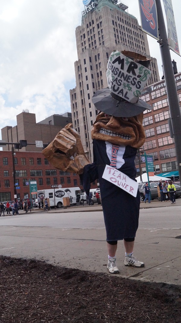 "Mr. Business as Usual," a CAST puppet outside Progressive Field at the Cleveland Indians' home opener. - SAM ALLARD / SCENE