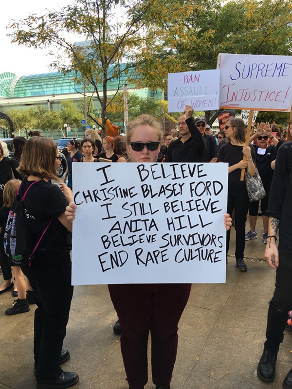 Lotte Brewer, 21, holding sign at the Cancel Kavanaugh protest in Cleveland - PHOTO BY GABRIELLE GREENE