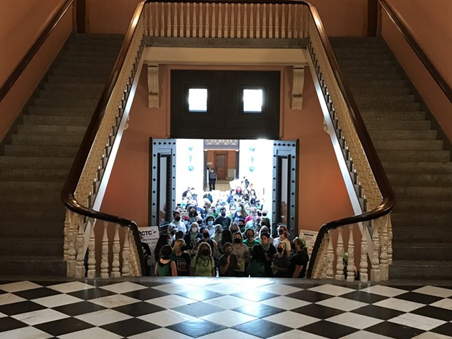 Abortion and pro-choice advocates walk into the rotunda of the Ohio Statehouse, on their way to demonstrate near the Senate chambers. The group protested the introduction of what would be a total abortion ban if Roe v. Wade is overturned. - Photo by Susan Tebben, OCJ.