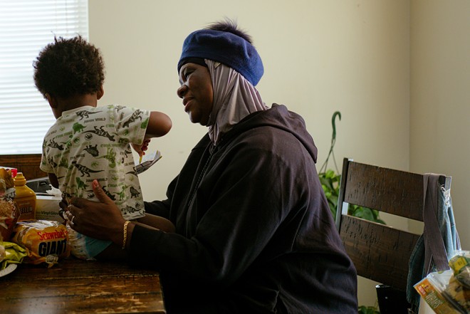 20220126_Utilities_RobinTurner-4 - Robin Turner, pictured with her grandson Treshawn Johnson Jr. in the kitchen of her Stockyards home on Jan. 26, has sought for months to reverify her enrollment in the PIPP assistance program, but she’s run into obstacles. Her utility bills, which totaled nearly $600 in January, make taking care of her family a challenge. - Photo by Michael Indriolo