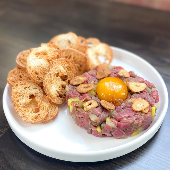 Beef tartare with soy-cured egg and garlic chips - Courtesy Terra Bistro