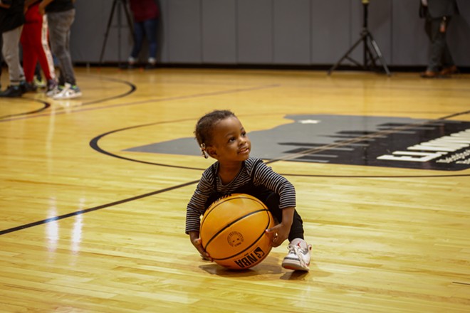 Chonte Calloway tests out a ball at Monday's gym opening. - Mark Oprea