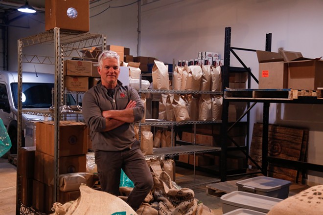 Joe Deinhart, the owner of Solstice Roasters, in his new roastery off East 9th and Carnegie in February. - Mark Oprea