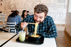 Brendan Trewella, the cofounder of Night Market Cleveland, eats noodles at Alpha Ramen on Payne, an anime-decorated ramen-and-bubble tea bar that opened this spring. - Mark Oprea