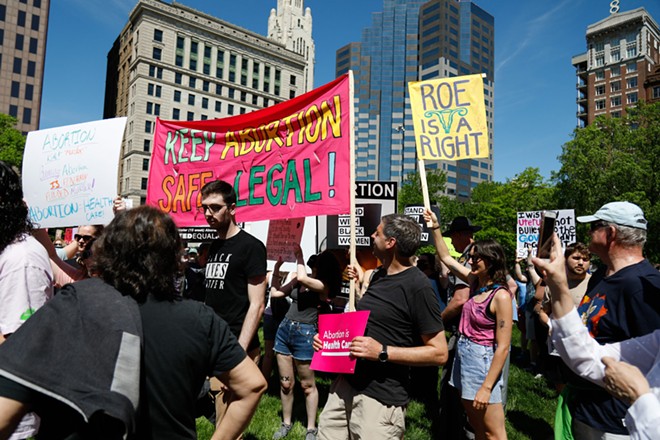 COLUMBUS, OH — MAY 14: Supporters of reproductive rights attempt to cover the posters of counter protesters at a rally to support abortion rights less than two weeks after a leaked Supreme Court draft opinion showed a likely reversal of Roe v. Wade, May 14, 2022, at the Ohio Statehouse, Columbus, Ohio. - Photo by Graham Stokes for the Ohio Capital Journal.