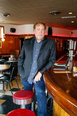 Sean Watterson, the owner of the Happy Dog and member of the Cleveland Music Club Coalition, at his bar on September 27, 2023. - Mark Oprea