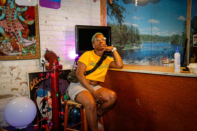 DeNavya Tolbert, 30, at a bar inside BLK Punx Press' indoor space. Tolbert started her DIY venue, which hosts everything from drag performers to alternative funk groups, as an artistic haven for the Black queer community. - Mark Oprea