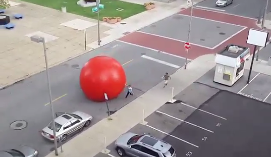 VIDEO: 250-Pound Red Ball Art Installation Goes Rogue, Rolls Through Toledo Streets